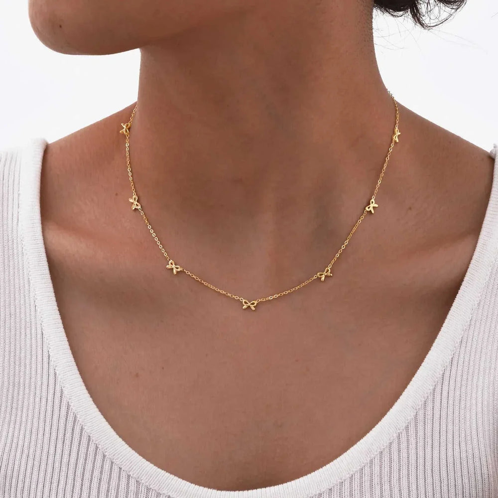 Gold dainty bow charm choker necklace on thin chain