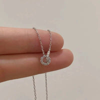 Sterling silver double ring zircon pendant necklace on a collarbone