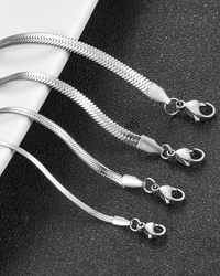 Flat herringbone snake chain necklace in gold and silver stainless steel with smooth, ribbon-like design