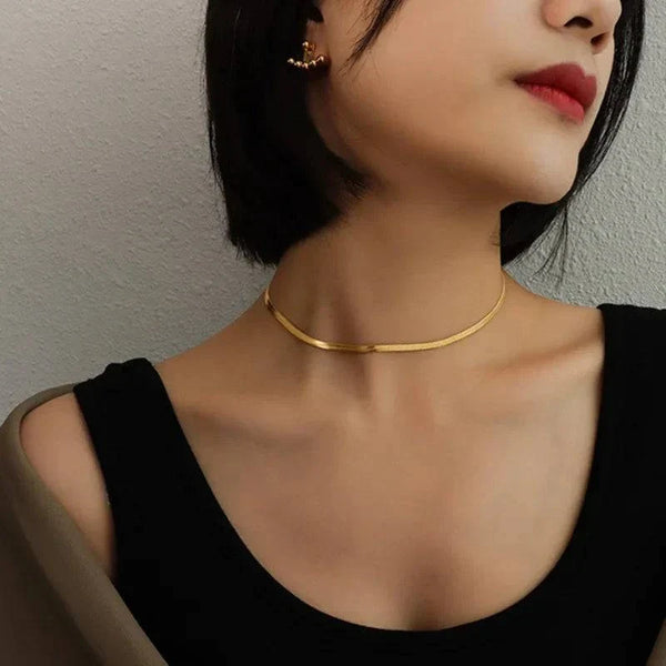 Flat herringbone snake chain necklace in gold and silver stainless steel, sleek and smooth design, available in multiple widths and lengths