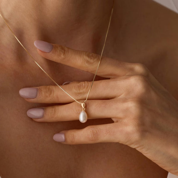 Freshwater pearl drop pendant necklace on delicate gold chain at collarbone length