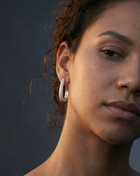 Silver plated Aria Pavé oval huggie earrings with cubic zirconia