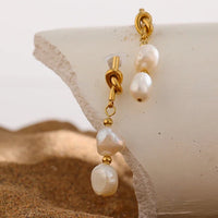 Knotted 14K gold pearl drop earrings with geometric design