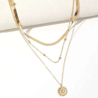 Gold Layered Coin Disc pendant on flat snake chain necklace against white background