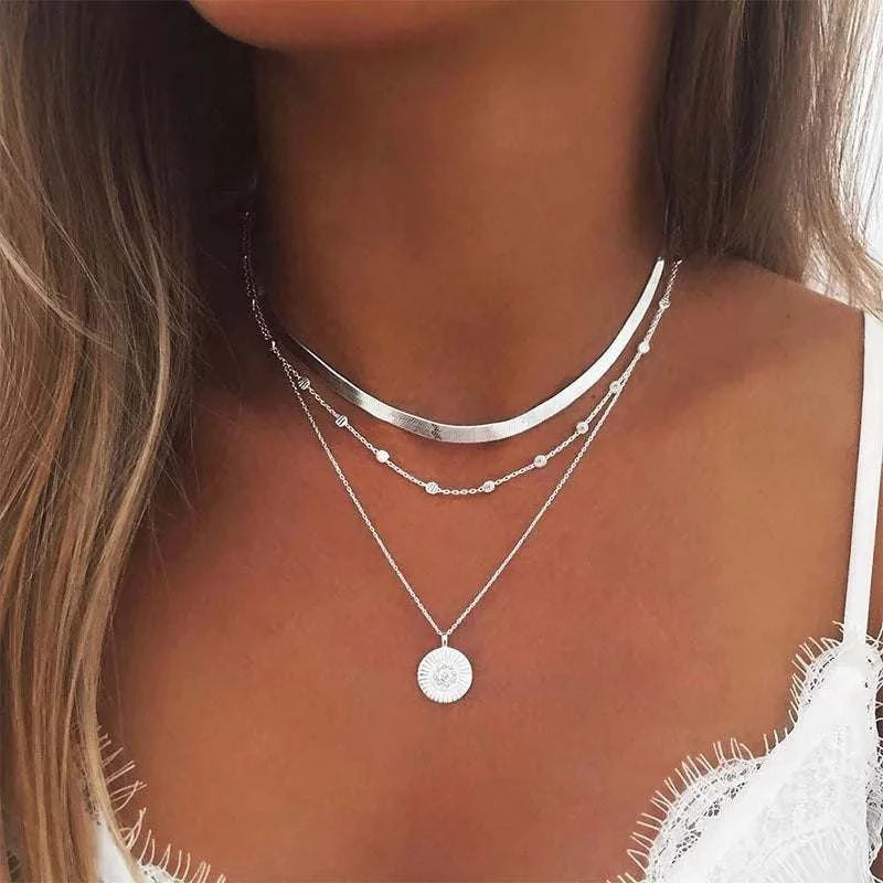 Gold layered coin disc pendant on flat snake chain necklace, minimalist jewelry design