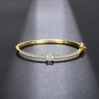 Lumiere bangle with cubic zirconia stones in silver and gold finishes