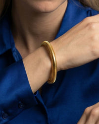 multi-strand stacked bangle set in gold and silver tones