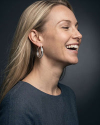 Silver plated orbit crossover hoop earrings with pavé cubic zirconia