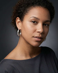 Silver plated orbit crossover hoop earrings with pavé cubic zirconia