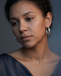 Silver plated orbit crossover hoop earrings with pavé cubic zirconia