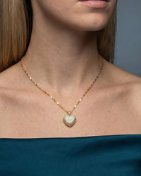 Gold heart pendant necklace with a pearl center