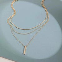 gold rectangle bar pendant necklace on collarbone chain
