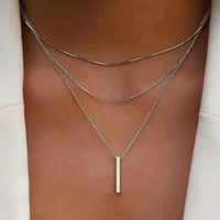 Gold rectangle bar pendant necklace on collarbone chain