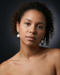 stainless steel sovereign coin huggie earrings with textured medallion