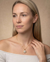 Spinning sunflower zircon pendant necklace in gold with sparkling layered petals