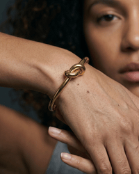 18K gold plated twisted knot cuff bangle on wrist minimalistic elegant design