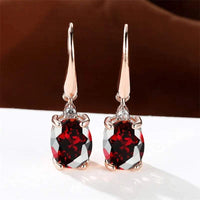 Rose gold long dangle earrings with oval cubic zirconia stones in multiple colors