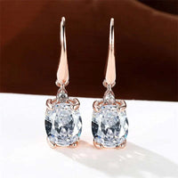 Rose gold long dangle earrings with oval zirconia stones in multiple colors