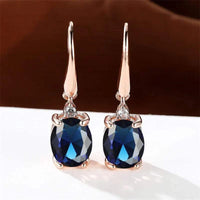 Rose gold long dangle earrings with vibrant oval zirconia stones